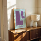 Modern interior design with a La Latina, Madrid, in Super Bold design, a typographic poster where the city map is overlaid with extra-thick lettering for a modern, high-impact look designed in purple and light blue, displayed on a living room wall