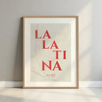 Framed La Latina, Madrid, in Classic design, inspired by chiseled typography with an elegant font that creates a beautiful visual contrast designed in red and an off-white background with a white margin border in a warm lit minimalist setting