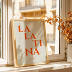 Modern interior design with a La Latina, Madrid, in Classic design, inspired by chiseled typography with an elegant font that creates a beautiful visual contrast designed in orange and an off-white background, displayed on a living room wall