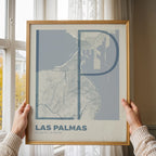 Modern interior design with a Las Palmas in Ultralight design, a minimalist aesthetic combining urban cartography with modern, extra-thin elegant lettering designed in bluish gray and an off-white background, displayed on a living room wall