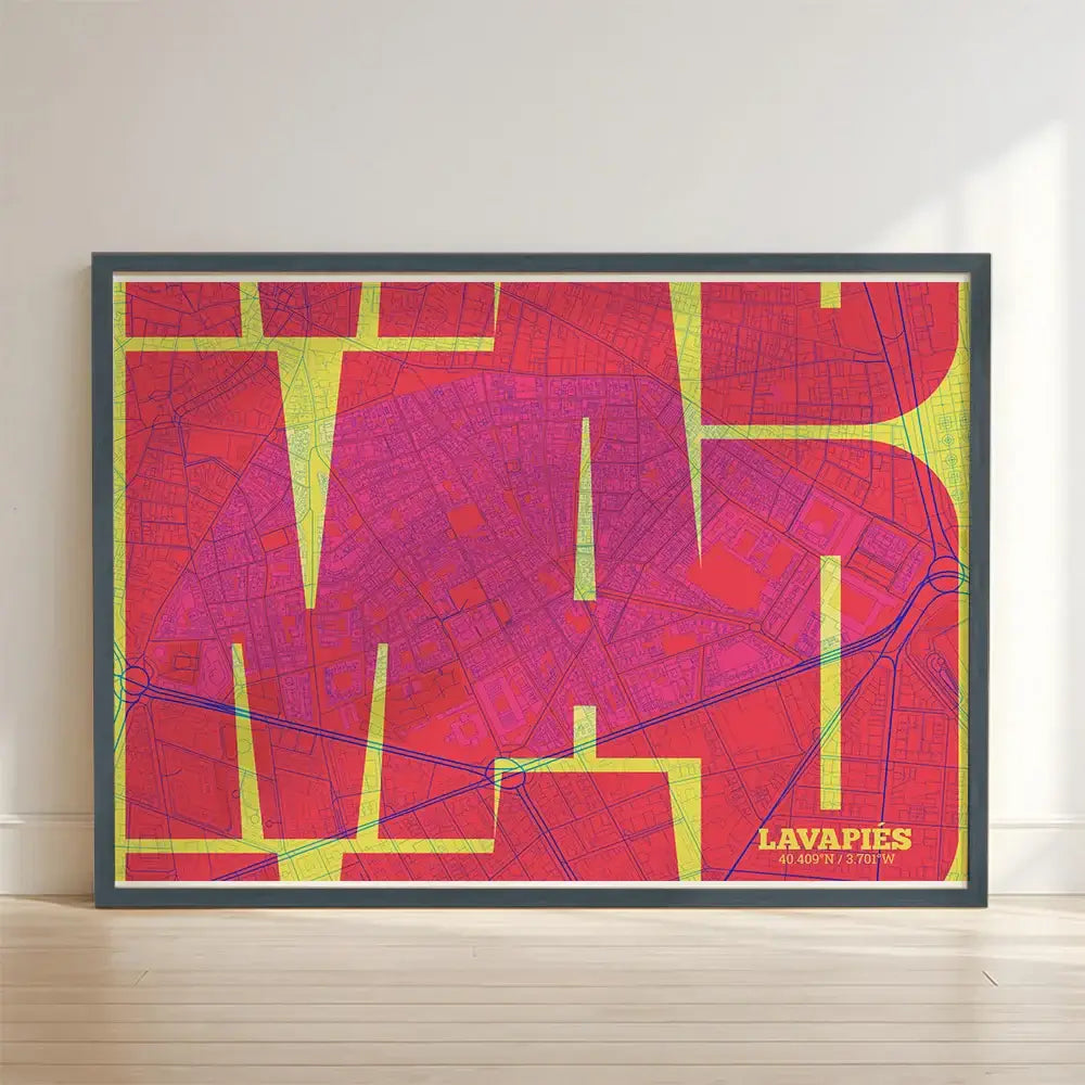 Framed Lavapies, Madrid, in Inseparable design, featuring the city's abbreviation in expressive typography over a detailed urban map designed in yellow and fuchsia with no border edge-to-edge print leaning against a wall