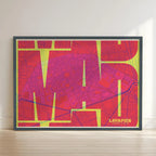 Framed Lavapies, Madrid, in Inseparable design, featuring the city's abbreviation in expressive typography over a detailed urban map designed in yellow and fuchsia with no border edge-to-edge print leaning against a wall