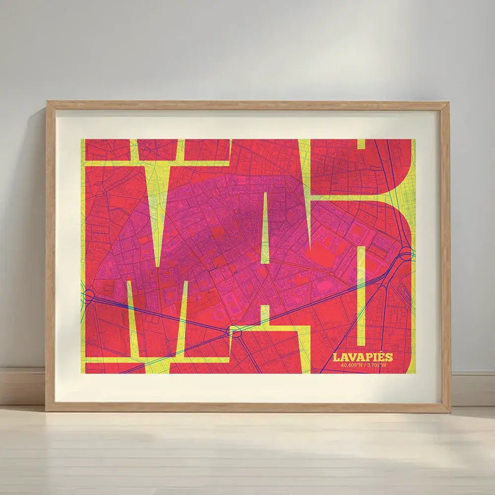 Framed Lavapies, Madrid, in Inseparable design, featuring the city's abbreviation in expressive typography over a detailed urban map designed in yellow and fuchsia with a white margin border in a warm lit minimalist setting
