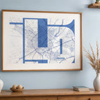 Modern interior design with a Lerida in Inseparable design, featuring the city's abbreviation in expressive typography over a detailed urban map designed in navy blue and white, displayed on a living room wall