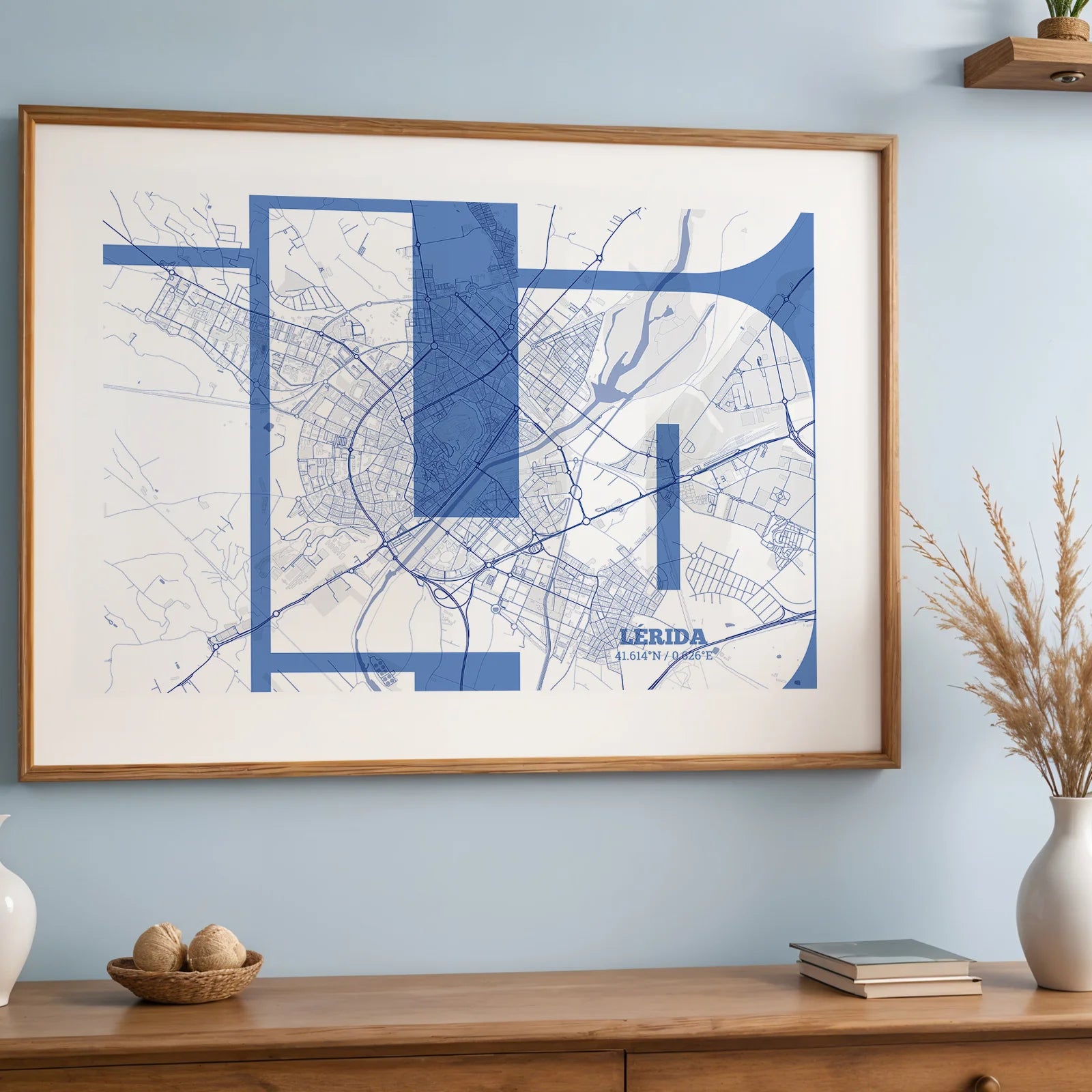 Modern interior design with a Lerida in Inseparable design, featuring the city's abbreviation in expressive typography over a detailed urban map designed in navy blue and white, displayed on a living room wall