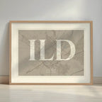 Framed Lleida in Classic design, inspired by chiseled typography with an elegant font that creates a beautiful visual contrast designed in light brown and an off-white background with a white margin border in a warm lit minimalist setting