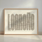 Framed Logroño in Extra Compressed design, where the letters are tightly squeezed to fit the city's map shape designed in light brown and an off-white background with a white margin border in a warm lit minimalist setting