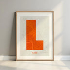 Framed Lugo in Super Bold design, a typographic poster where the city map is overlaid with extra-thick lettering for a modern, high-impact look designed in orange and an off-white background with a white margin border in a warm lit minimalist setting