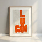 Framed Lugo in Unruled design, where the city name letters appear randomly across different lines for a truly original urban layout designed in orange and an off-white background with a white margin border in a warm lit minimalist setting