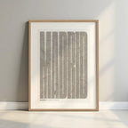 Framed Madrid in Extra Compressed design, where the letters are tightly squeezed to fit the city's map shape designed in light brown and an off-white background with a white margin border in a warm lit minimalist setting