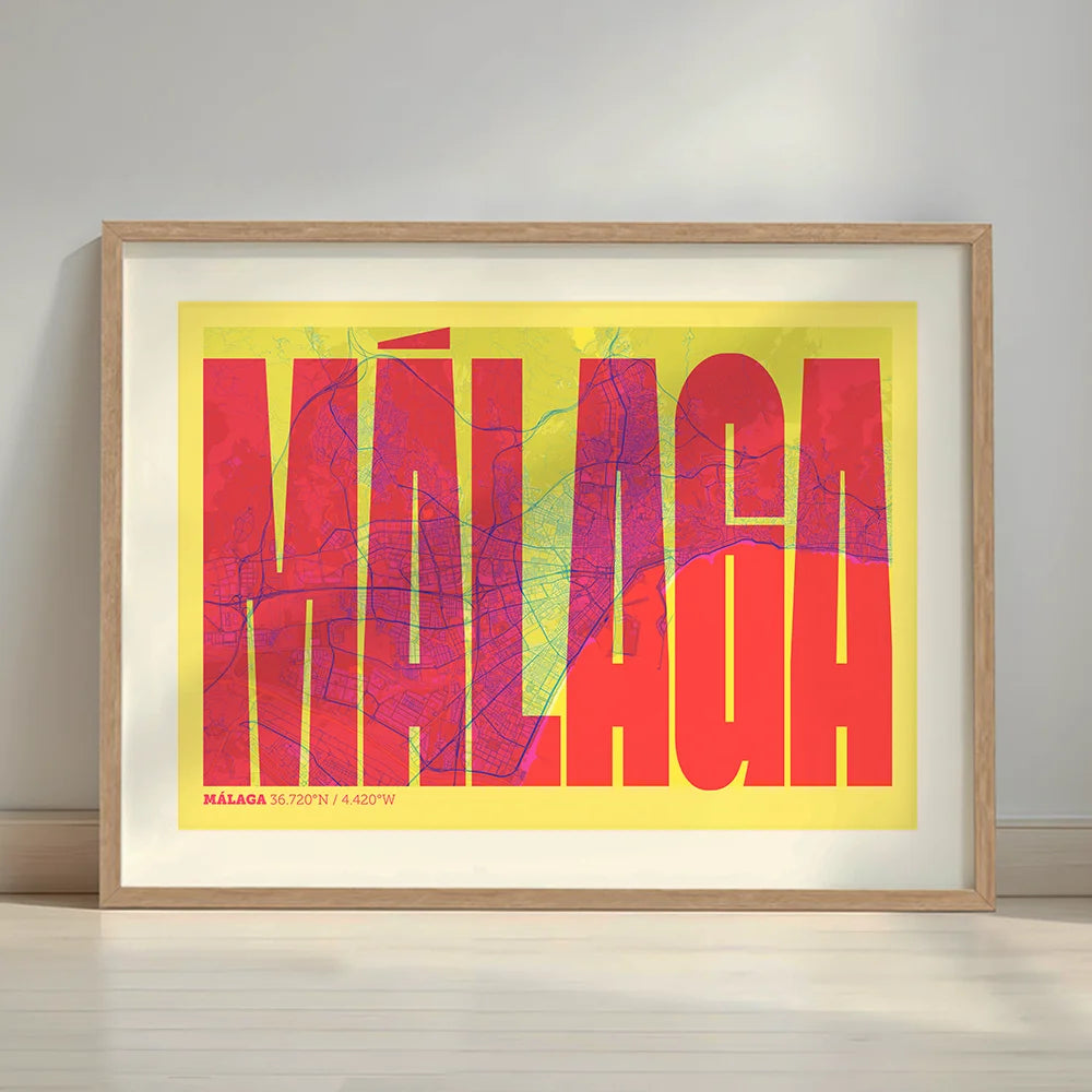 Framed Malaga in Extra Compressed design, where the letters are tightly squeezed to fit the city's map shape designed in yellow and fuchsia with a white margin border in a warm lit minimalist setting