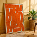 Modern interior design with a Malasaña, Madrid, in Inseparable design, featuring the city's abbreviation in expressive typography over a detailed urban map designed in orange and an off-white background, displayed on a living room wall