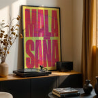 Modern interior design with a Malasaña, Madrid, in Extra Compressed design, where the letters are tightly squeezed to fit the city's map shape designed in yellow and fuchsia, displayed on a living room wall