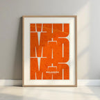 Framed Malasaña, Madrid, in Inseparable design, featuring the city's abbreviation in expressive typography over a detailed urban map designed in orange and an off-white background with a white margin border in a warm lit minimalist setting