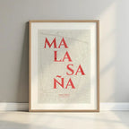 Framed Malasaña, Madrid, in Classic design, inspired by chiseled typography with an elegant font that creates a beautiful visual contrast designed in orange and an off-white background with a white margin border in a warm lit minimalist setting