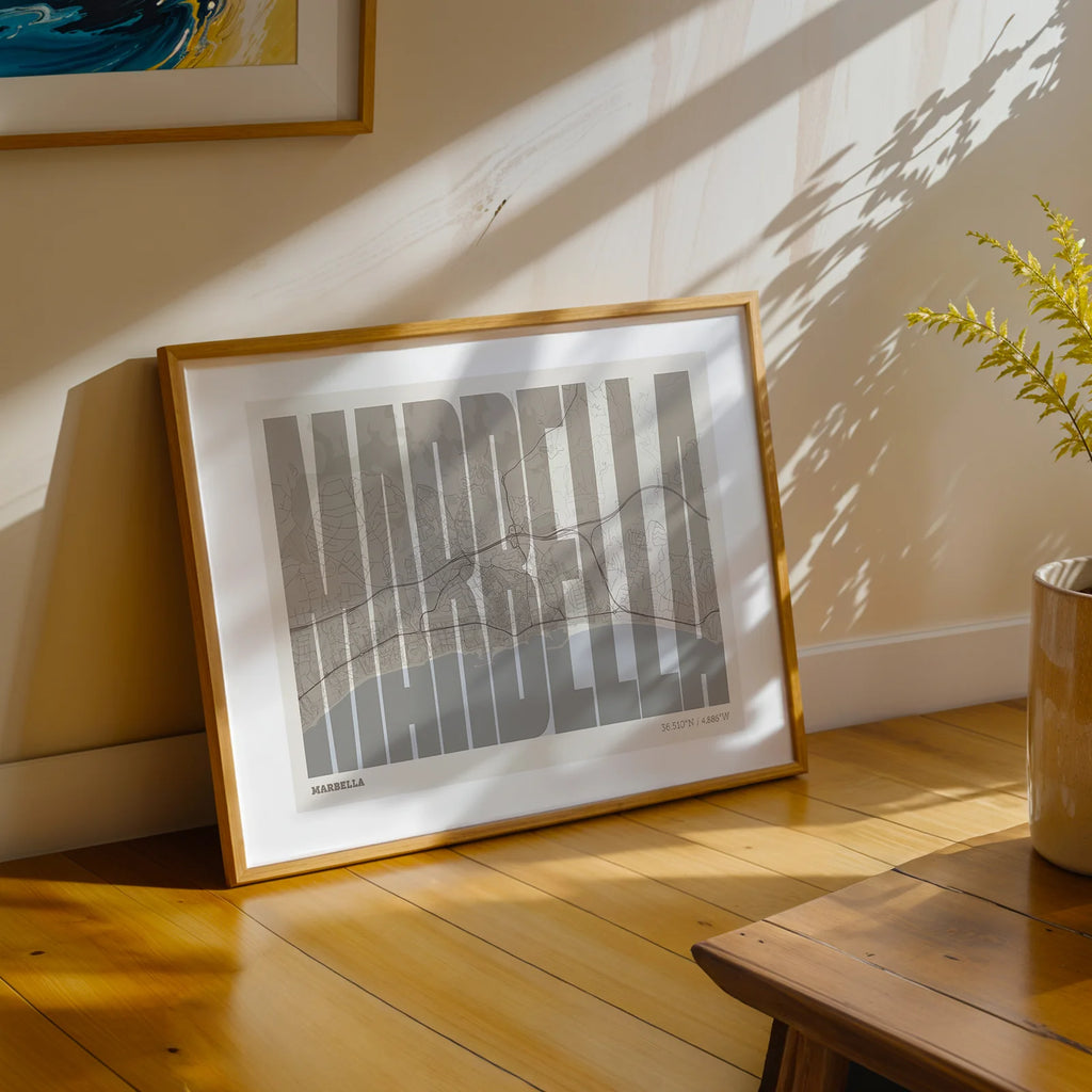 Modern interior design with a Marbella in Extra Compressed design, where the letters are tightly squeezed to fit the city's map shape designed in light brown and an off-white background, displayed on a living room wall