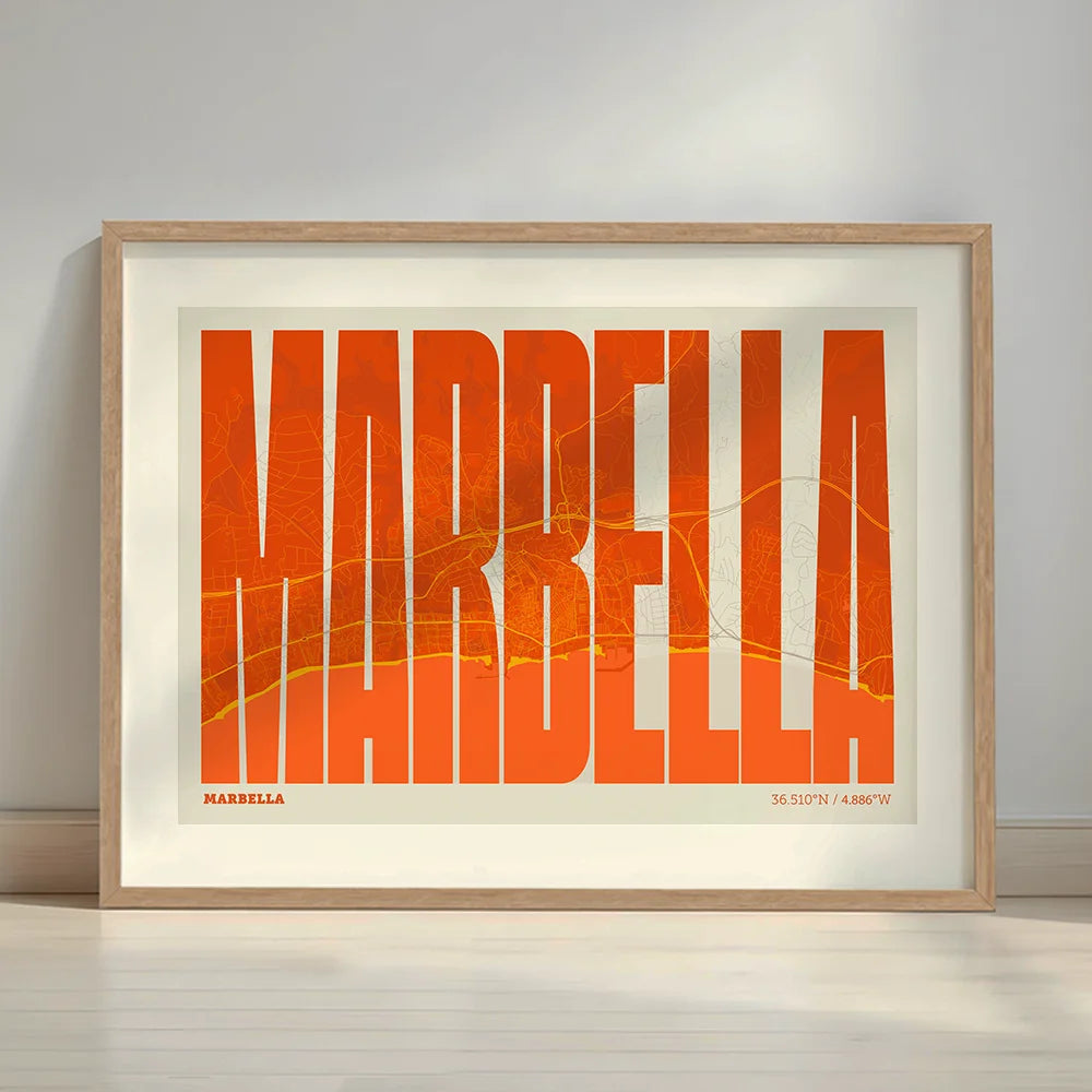 Framed Marbella in Extra Compressed design, where the letters are tightly squeezed to fit the city's map shape designed in orange and an off-white background with a white margin border in a warm lit minimalist setting