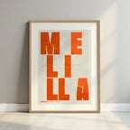 Framed Melilla in Unruled design, where the city name letters appear randomly across different lines for a truly original urban layout designed in orange and an off-white background with a white margin border in a warm lit minimalist setting