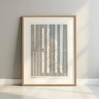 Framed Melilla in Extra Compressed design, where the letters are tightly squeezed to fit the city's map shape designed in light brown and an off-white background with a white margin border in a warm lit minimalist setting