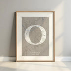 Framed Ourense in Classic design, inspired by chiseled typography with an elegant font that creates a beautiful visual contrast designed in light brown and an off-white background with a white margin border in a warm lit minimalist setting