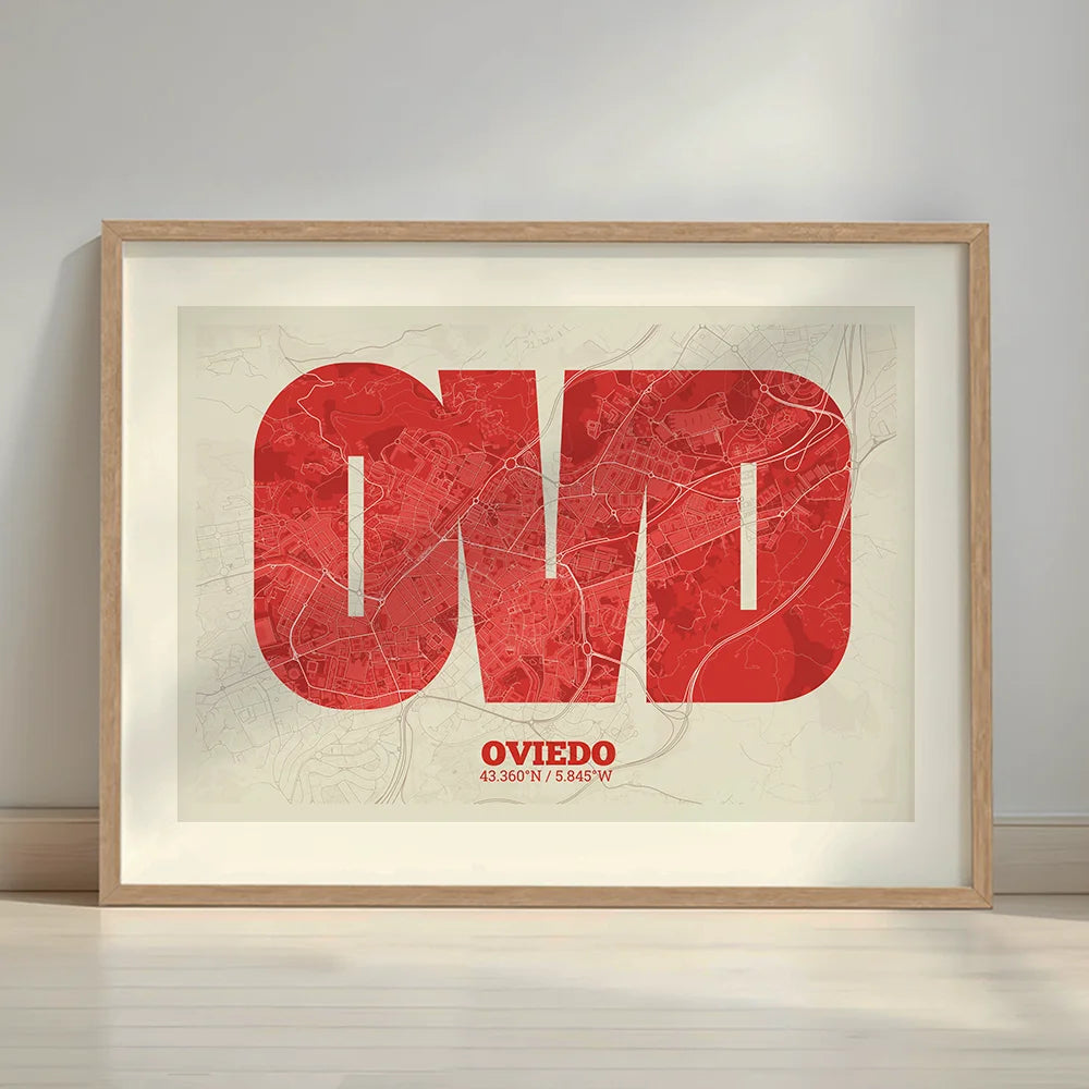 Framed Oviedo in Super Bold design, a typographic poster where the city map is overlaid with extra-thick lettering for a modern, high-impact look designed in red and an off-white background with a white margin border in a warm lit minimalist setting