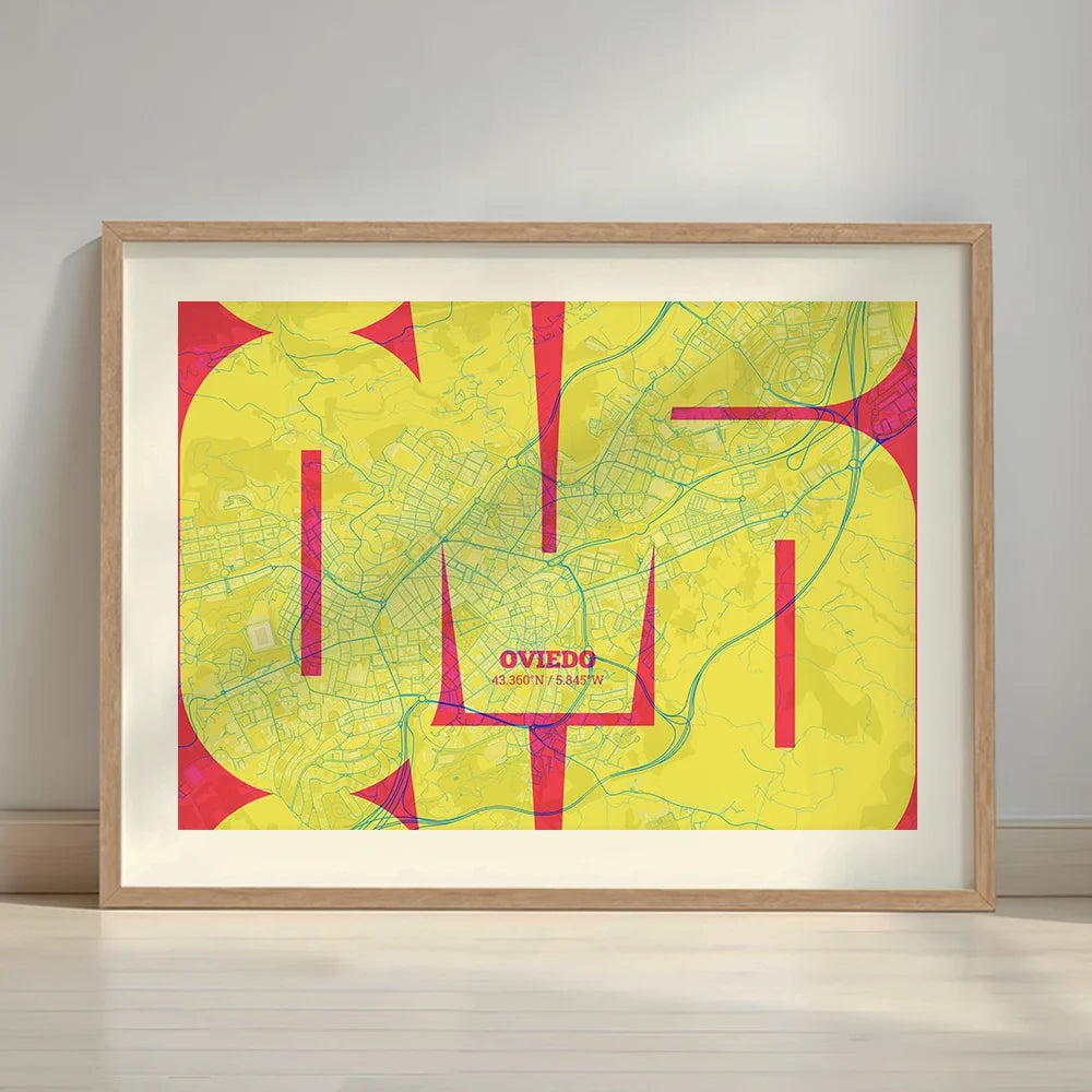 Framed Oviedo in Inseparable design, featuring the city's abbreviation in expressive typography over a detailed urban map designed in yellow and fuchsia with a white margin border in a warm lit minimalist setting