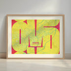 Framed Oviedo in Inseparable design, featuring the city's abbreviation in expressive typography over a detailed urban map designed in yellow and fuchsia with a white margin border in a warm lit minimalist setting