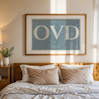 Modern interior design with a Oviedo in Classic design, inspired by chiseled typography with an elegant font that creates a beautiful visual contrast designed in bluish gray and an off-white background, displayed on a living room wall