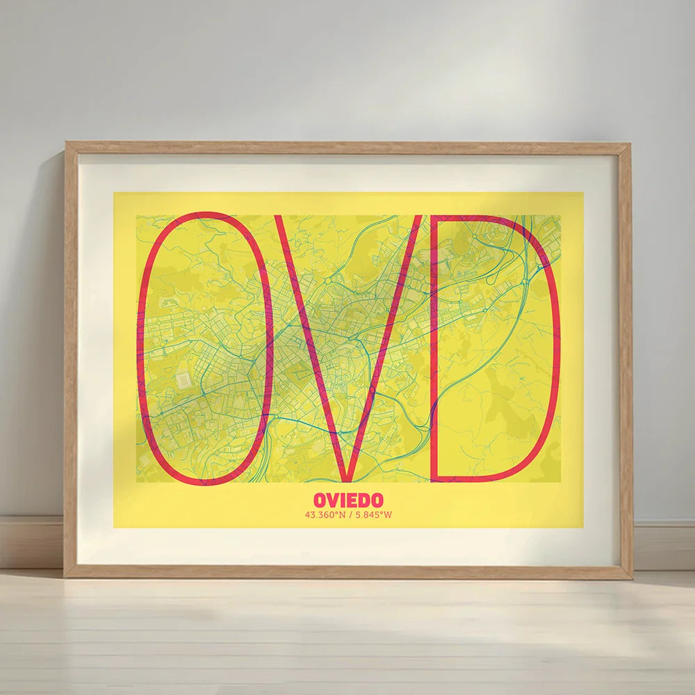 Framed Oviedo in Ultralight design, a minimalist aesthetic combining urban cartography with modern, extra-thin elegant lettering designed in yellow and fuchsia with a white margin border in a warm lit minimalist setting