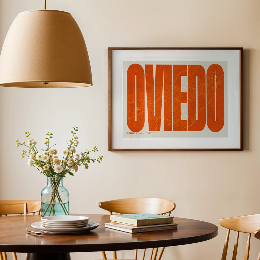 Modern interior design with a Oviedo in Extra Compressed design, where the letters are tightly squeezed to fit the city's map shape designed in orange and an off-white background, displayed on a living room wall