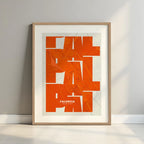 Framed Palencia in Inseparable design, featuring the city's abbreviation in expressive typography over a detailed urban map designed in orange and an off-white background with a white margin border in a warm lit minimalist setting