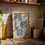 Modern interior design with a Palencia in Unruled design, where the city name letters appear randomly across different lines for a truly original urban layout designed in bluish gray and an off-white background, displayed on a living room wall