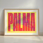 Framed Palma in Extra Compressed design, where the letters are tightly squeezed to fit the city's map shape designed in yellow and fuchsia with a white margin border in a warm lit minimalist setting