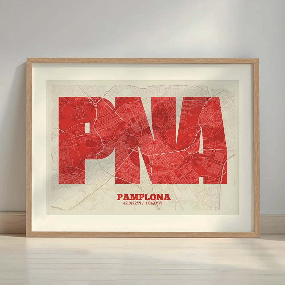 Framed Pamplona in Super Bold design, a typographic poster where the city map is overlaid with extra-thick lettering for a modern, high-impact look designed in red and an off-white background with a white margin border in a warm lit minimalist setting