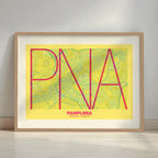 Framed Pamplona in Ultralight design, a minimalist aesthetic combining urban cartography with modern, extra-thin elegant lettering designed in yellow and fuchsia with a white margin border in a warm lit minimalist setting