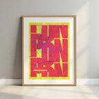 Framed Pontevedra in Inseparable design, featuring the city's abbreviation in expressive typography over a detailed urban map designed in yellow and fuchsia with a white margin border in a warm lit minimalist setting