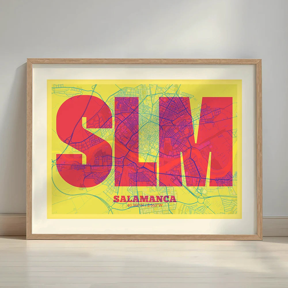 Framed Salamanca in Super Bold design, a typographic poster where the city map is overlaid with extra-thick lettering for a modern, high-impact look designed in yellow and fuchsia with a white margin border in a warm lit minimalist setting
