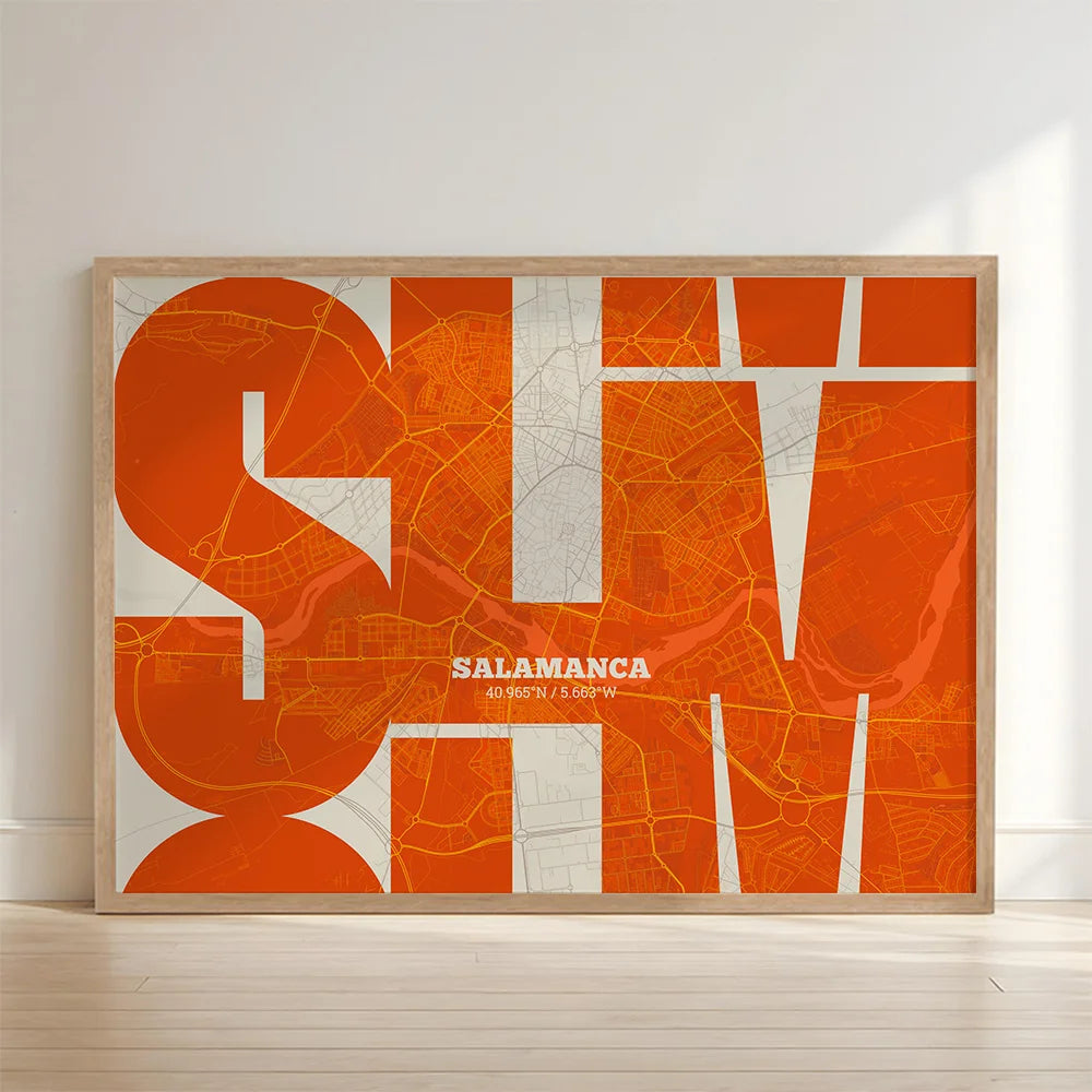 Framed Salamanca in Inseparable design, featuring the city's abbreviation in expressive typography over a detailed urban map designed in orange and an off-white background with no border edge-to-edge print leaning against a wall