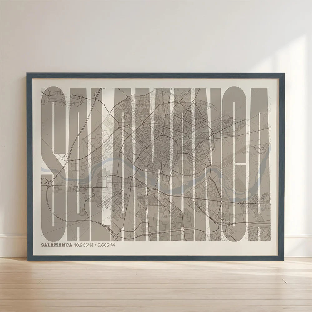 Framed Salamanca in Extra Compressed design, where the letters are tightly squeezed to fit the city's map shape designed in light brown and an off-white background with no border edge-to-edge print leaning against a wall