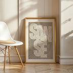 Modern interior design with a San Sebastian de los Reyes in Inseparable design, featuring the city's abbreviation in expressive typography over a detailed urban map designed in light brown and an off-white background, displayed on a living room wall