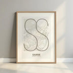 Framed San Sebastian de los Reyes in Ultralight design, a minimalist aesthetic combining urban cartography with modern, extra-thin elegant lettering designed in light brown and an off-white background with a white margin border in a warm lit minimalist setting
