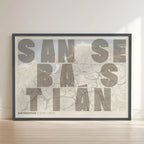Framed San Sebastian in Unruled design, where the city name letters appear randomly across different lines for a truly original urban layout designed in light brown and an off-white background with no border edge-to-edge print leaning against a wall