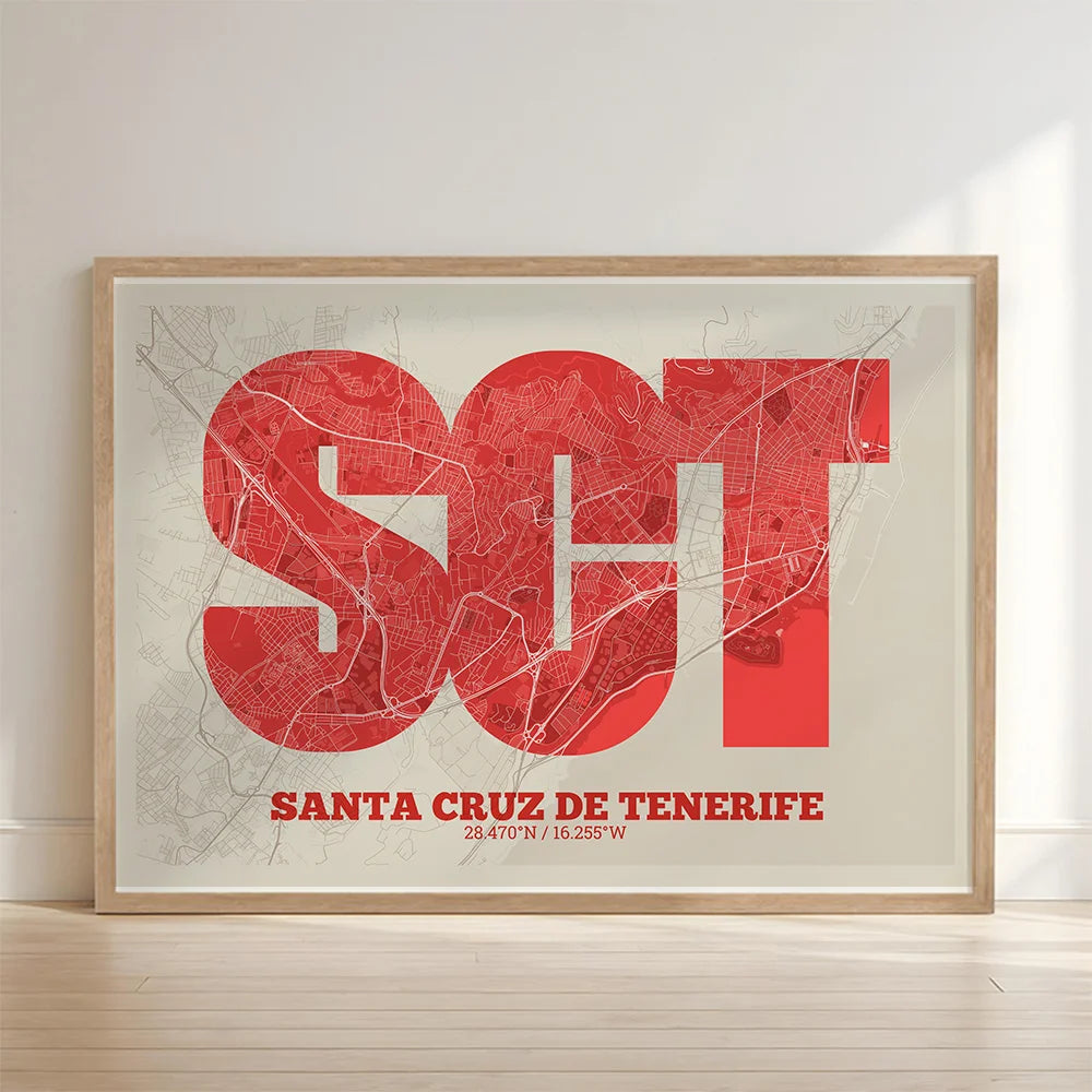 Framed Santa Cruz de Tenerife in Super Bold design, a typographic poster where the city map is overlaid with extra-thick lettering for a modern, high-impact look designed in red and an off-white background with no border edge-to-edge print leaning against a wall
