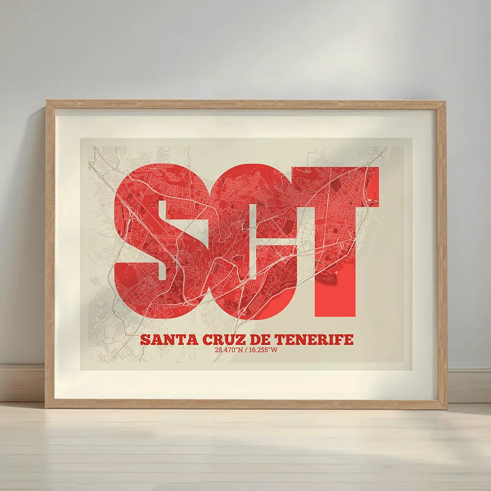 Framed Santa Cruz de Tenerife in Super Bold design, a typographic poster where the city map is overlaid with extra-thick lettering for a modern, high-impact look designed in red and an off-white background with a white margin border in a warm lit minimalist setting