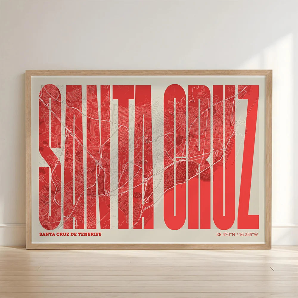 Framed Santa Cruz de Tenerife in Extra Compressed design, where the letters are tightly squeezed to fit the city's map shape designed in red and an off-white background with no border edge-to-edge print leaning against a wall