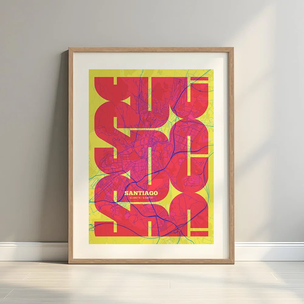 Framed Santiago de Compostela in Inseparable design, featuring the city's abbreviation in expressive typography over a detailed urban map designed in yellow and fuchsia with a white margin border in a warm lit minimalist setting