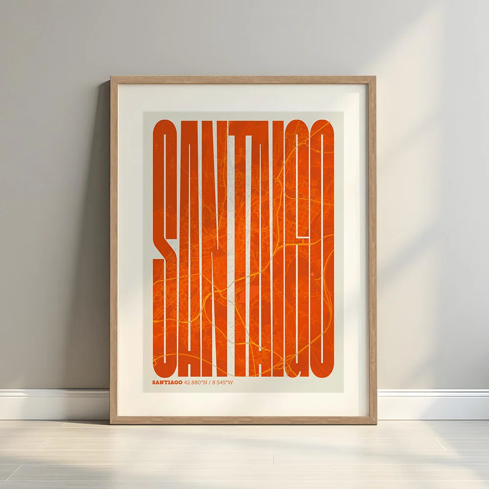 Framed Santiago de Compostela in Extra Compressed design, where the letters are tightly squeezed to fit the city's map shape designed in orange and an off-white background with a white margin border in a warm lit minimalist setting
