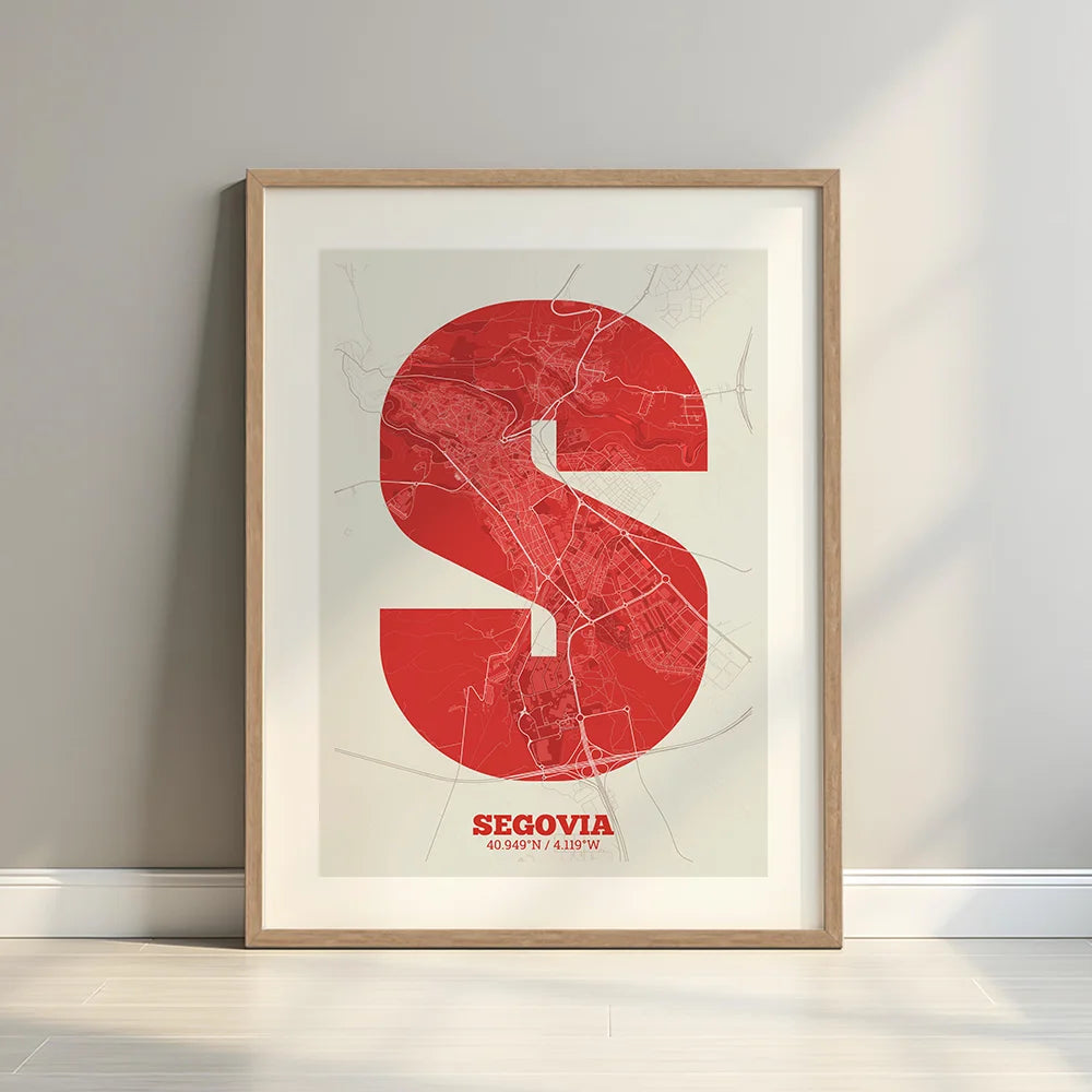 Framed Segovia in Super Bold design, a typographic poster where the city map is overlaid with extra-thick lettering for a modern, high-impact look designed in red and an off-white background with a white margin border in a warm lit minimalist setting