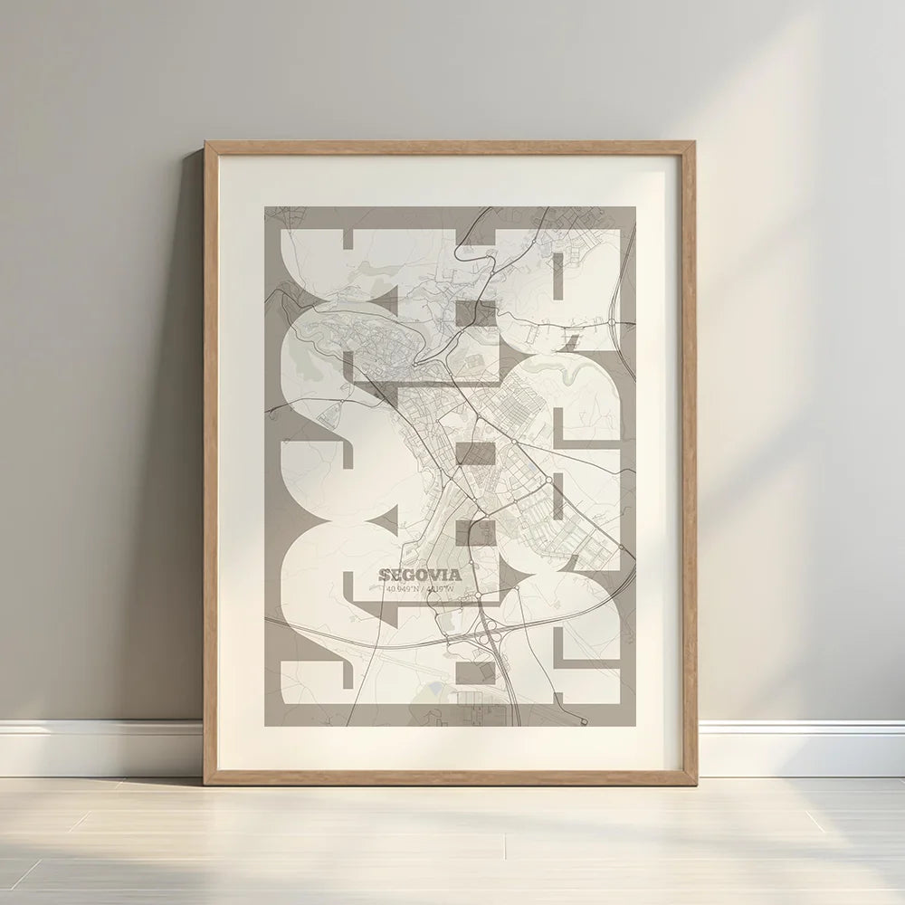 Framed Segovia in Inseparable design, featuring the city's abbreviation in expressive typography over a detailed urban map designed in light brown and an off-white background with a white margin border in a warm lit minimalist setting