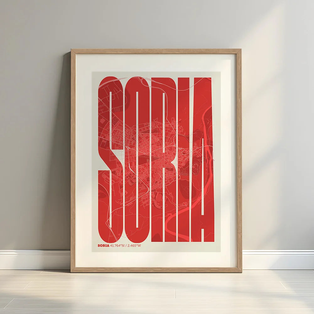 Framed Soria in Extra Compressed design, where the letters are tightly squeezed to fit the city's map shape designed in red and an off-white background with a white margin border in a warm lit minimalist setting